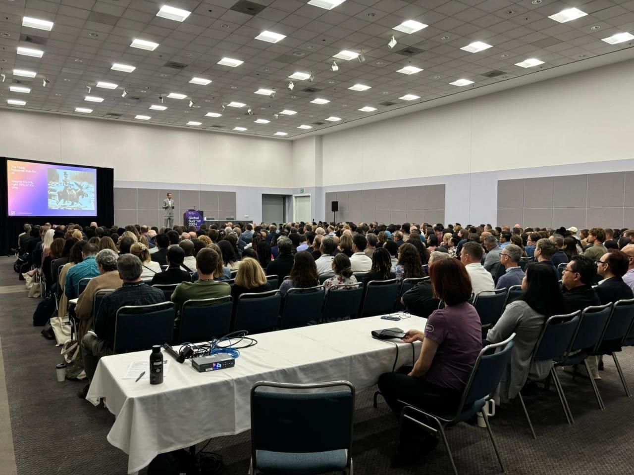 Alexander Moen presenting to a packed audience at a professional conference